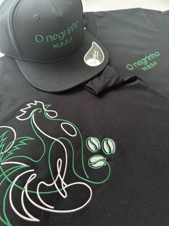 Black cap and t-shirt with detailed green and white embroidery, made by Embroidery Madeira