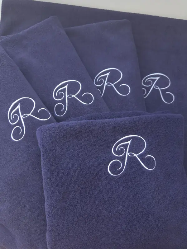 Navy beach towels embroidered with an R monogram for Reid's Palace